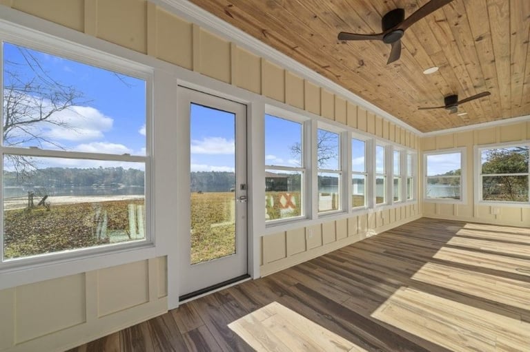 sunroom in Buckhead Lake, GA custom home by PAXISgroup with lake views and wood ceiling