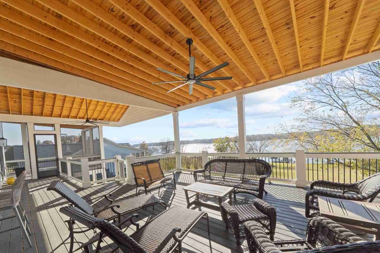 Oconee Heights, GA custom home covered deck by PAXISgroup featuring vaulted wood ceiling and lounge seating