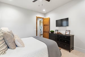 Bedroom with Light Blue Walls and Rich Wood Door | PAXISgroup