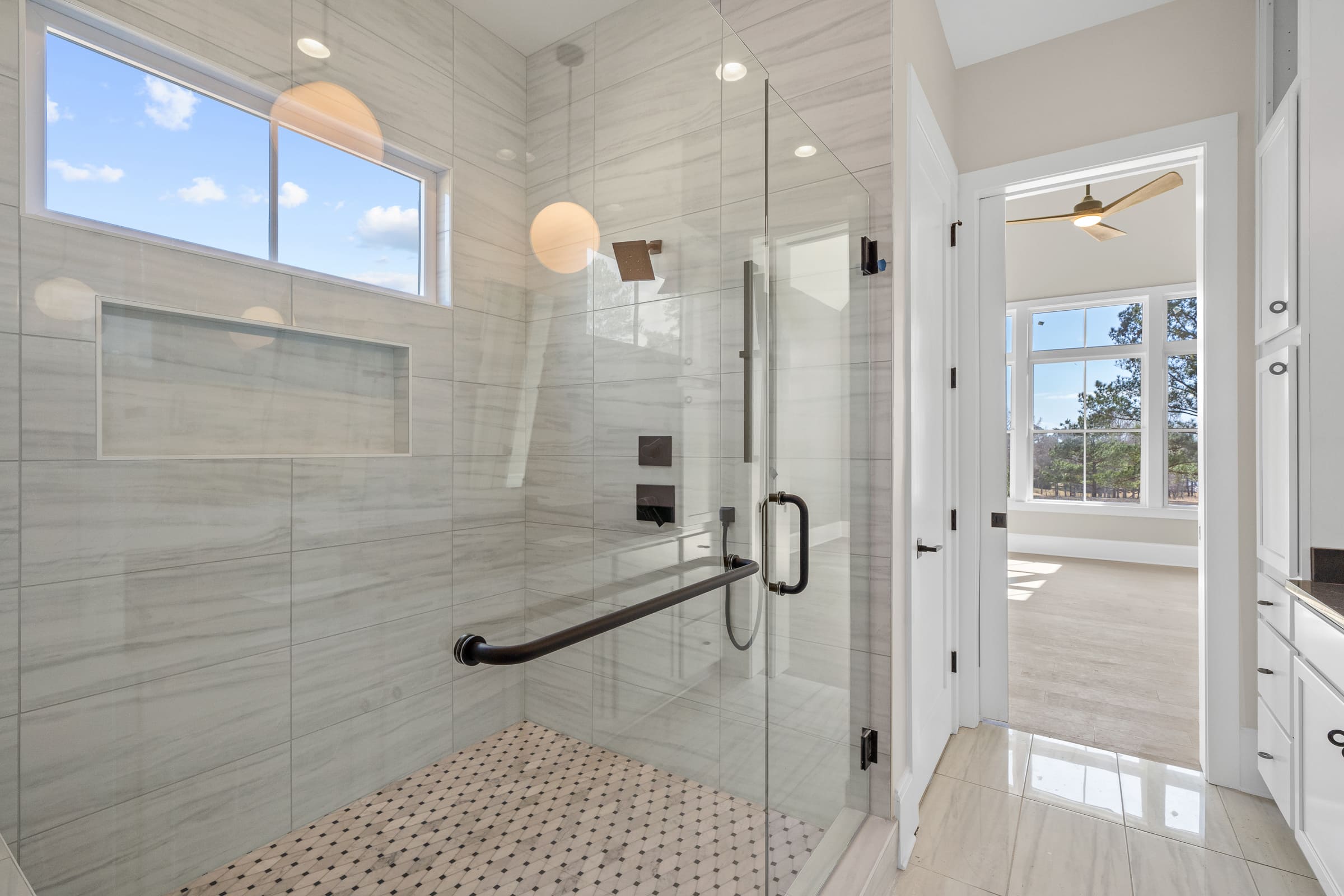 Primary Bathroom Shower with Large Glass Doors and Gorgeous Tiling Features |PAXISgroup