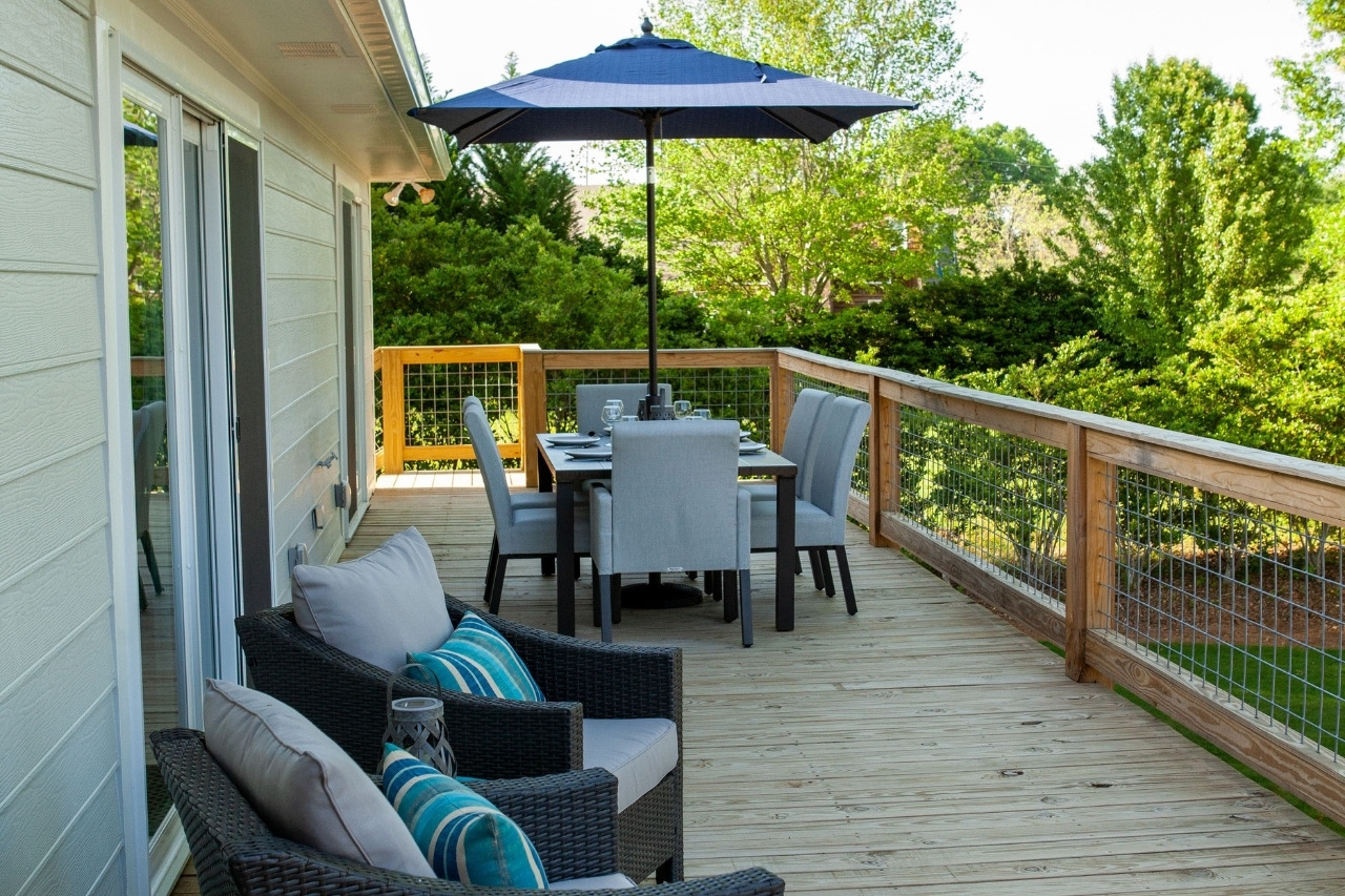 Back Patio with Furniture in Lakefront Home Remodel | PAXISgroup Custom Home Builders in GA