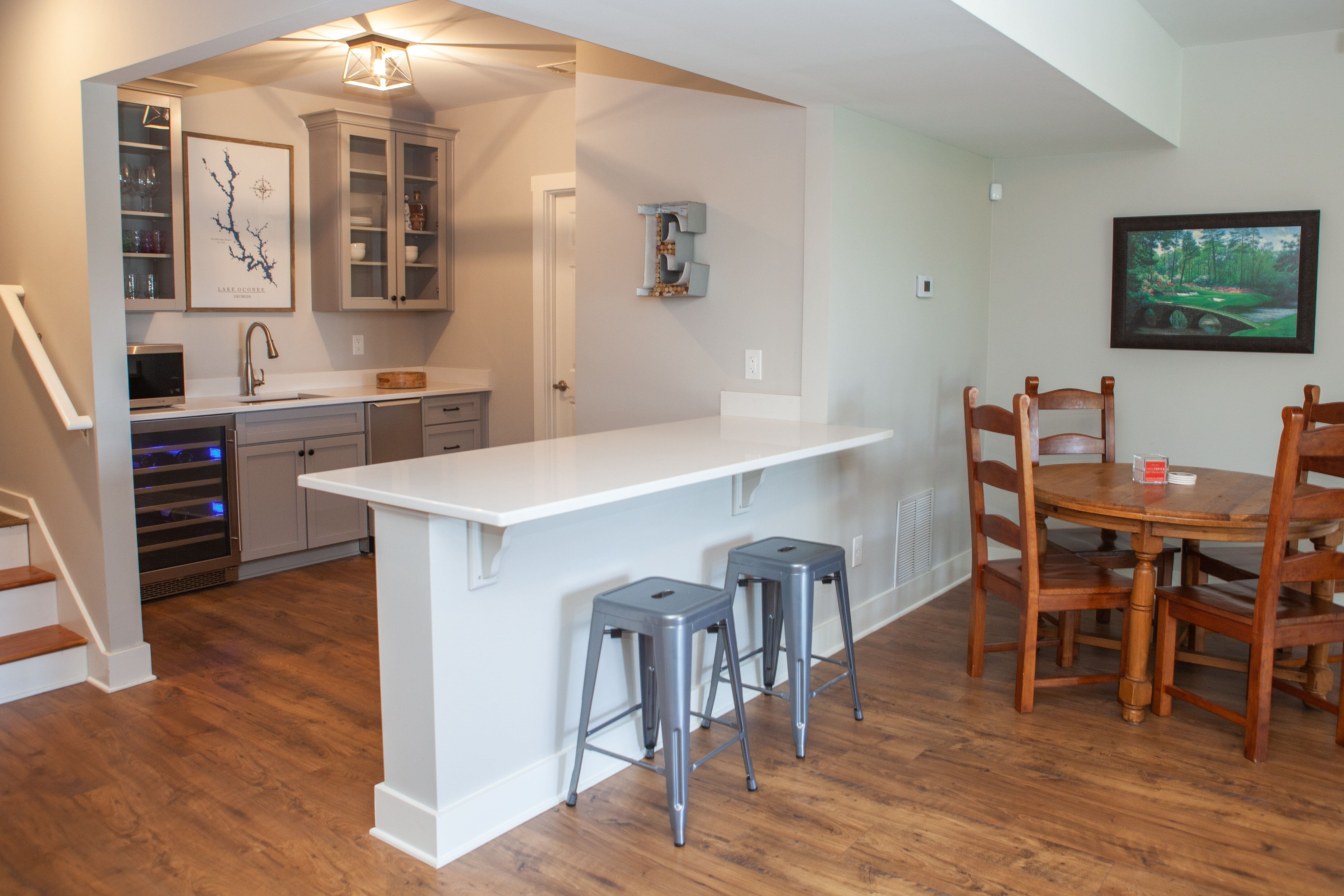 Downstairs Bar with Bar Seating and Wine or Beverage Cooler | PAXISgroup Custom Home Builders in GA Downstairs Bar with Bar Seating and Wine or Beverage Cooler | PAXISgroup Custom Home Builders in GA