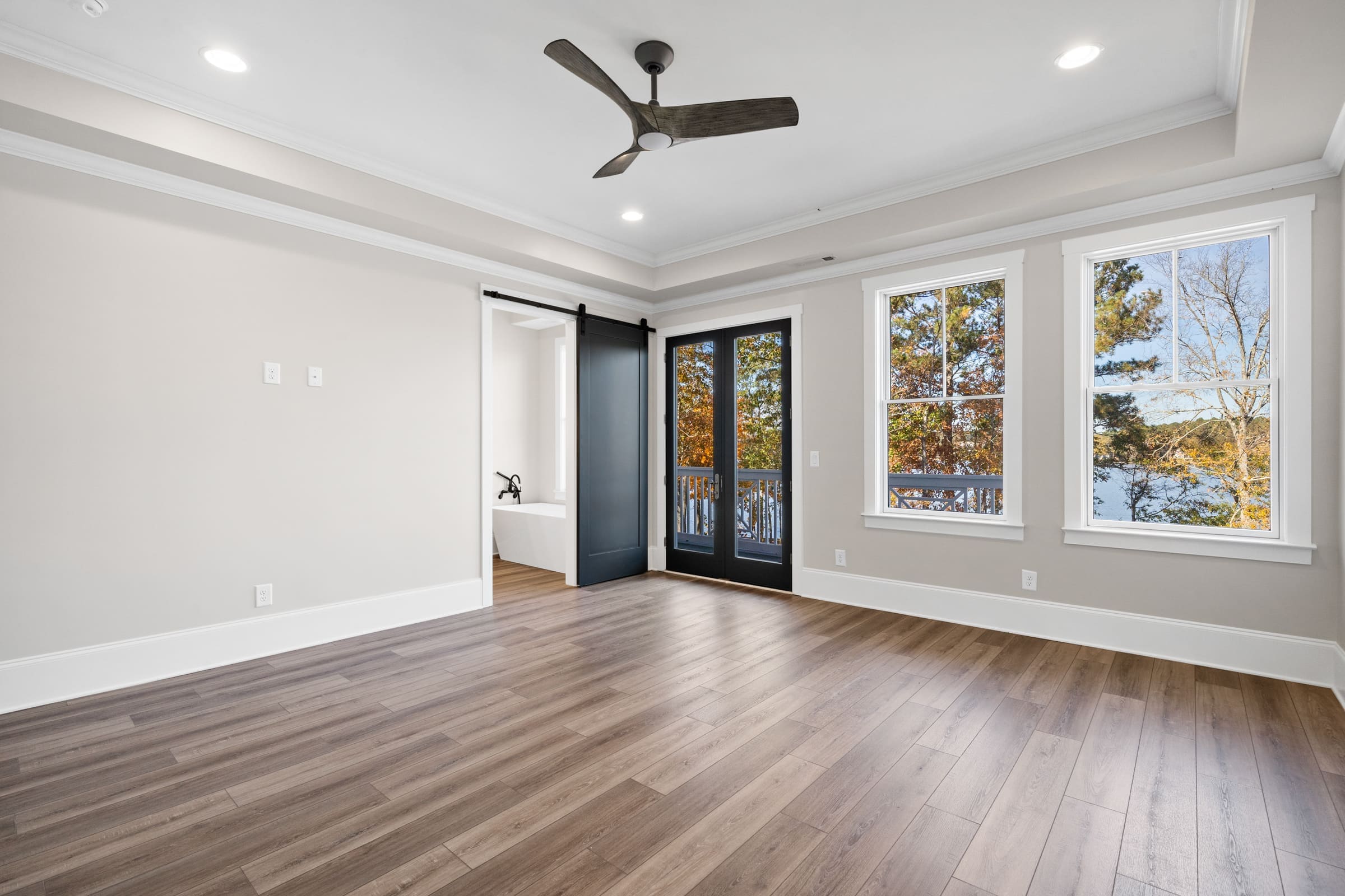 Hard Wood Bedroom Floor with Many Windows Allowing Plenty of Natural Light 