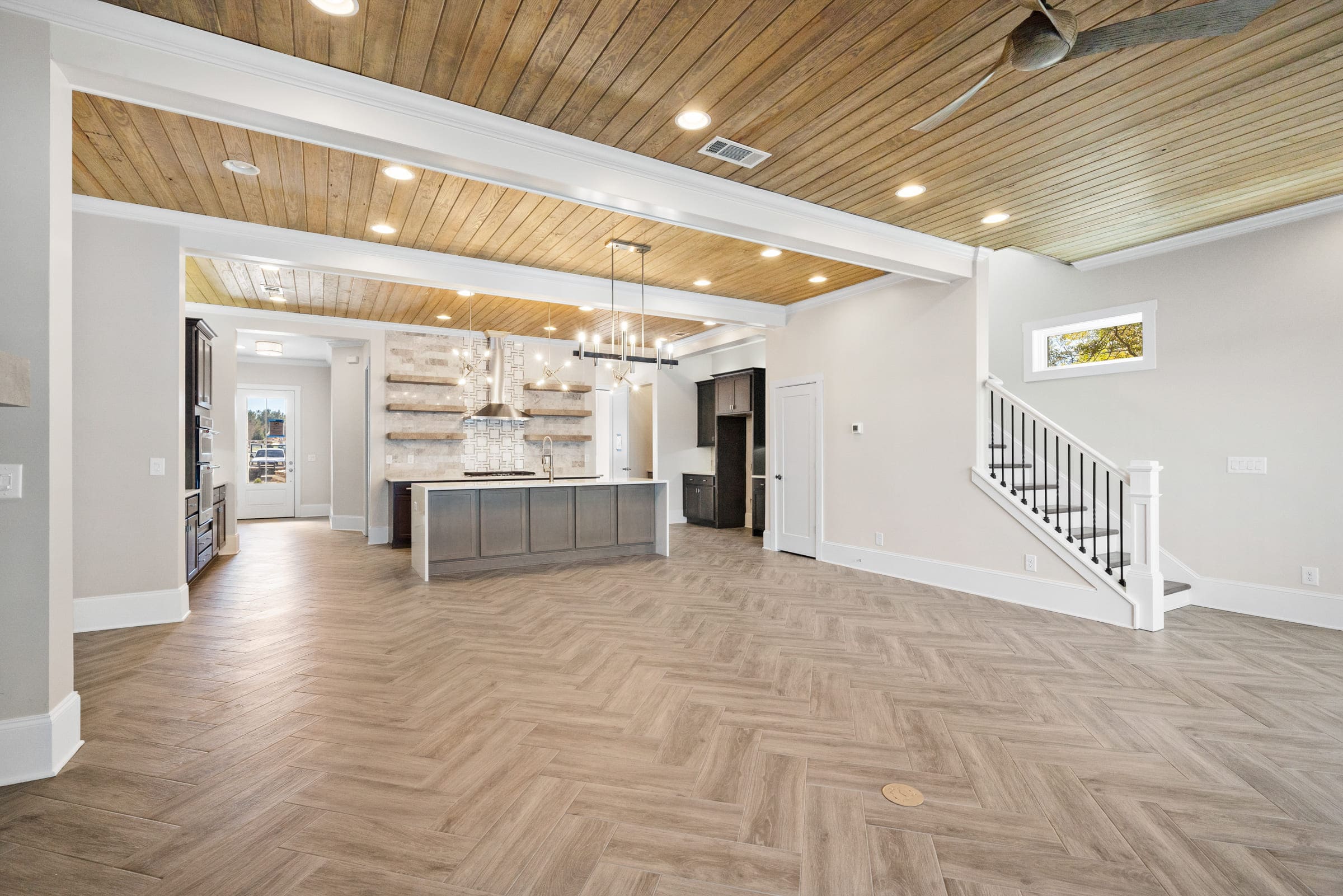 Detailed Hardwood Floor with Gorgeous View of Downstairs Kitchen Area  
