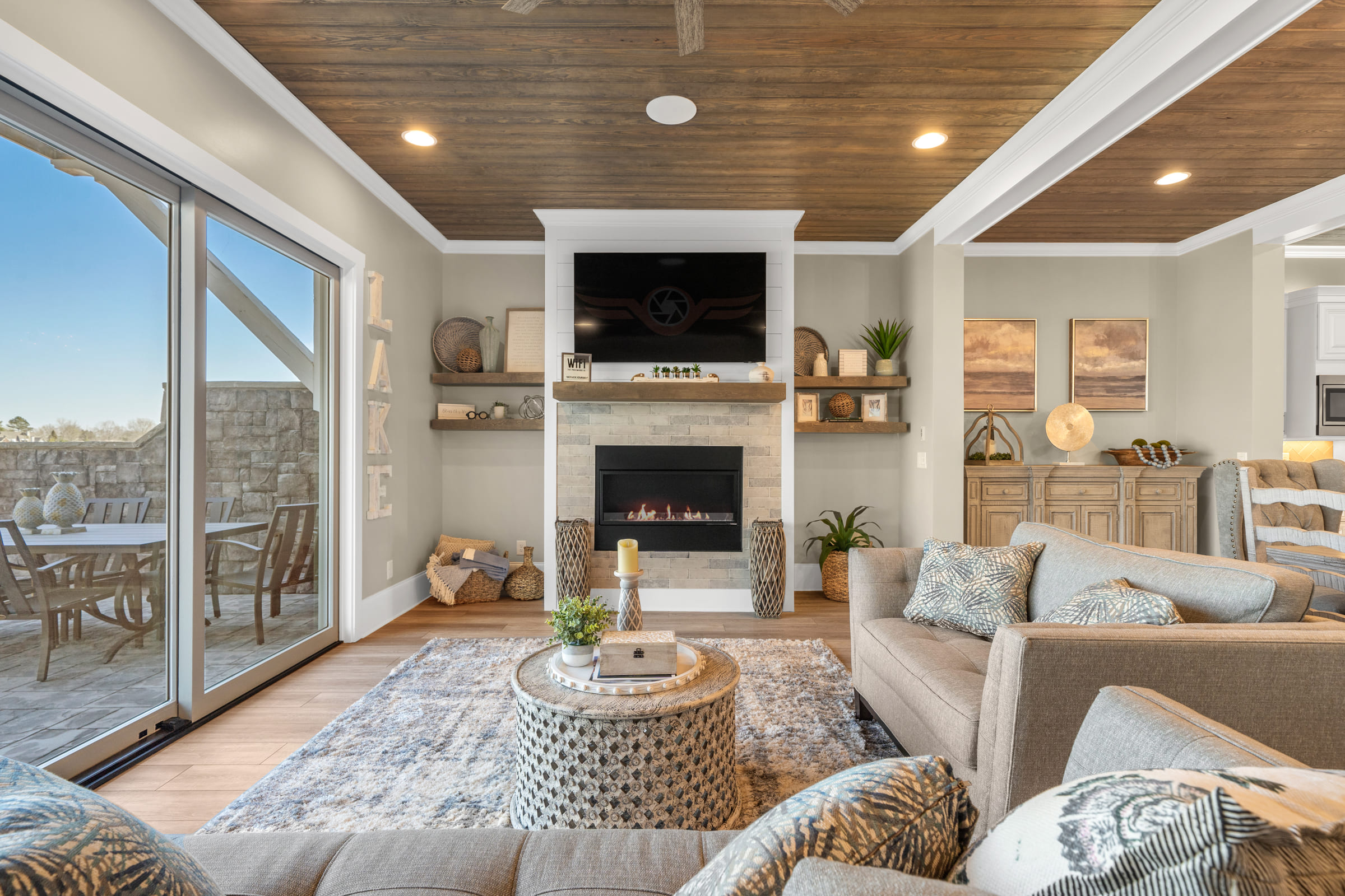 Beautiful Family Room with Built-in Fire Place with Light Stone and Wood Ceiling |PAXISgroup