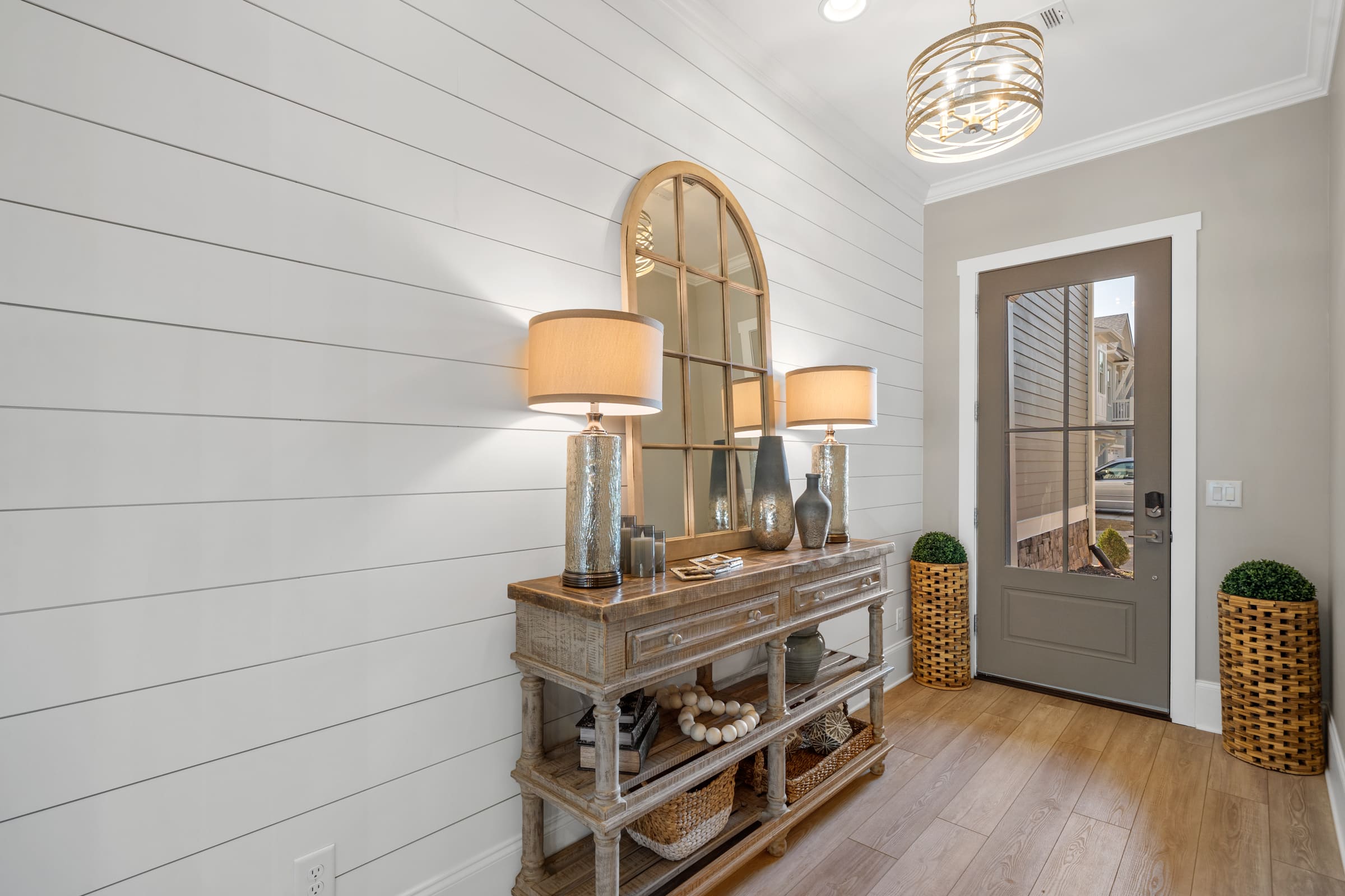 Front Door Entrance with Large Paneled Wall and Unique Light |PAXISgroup