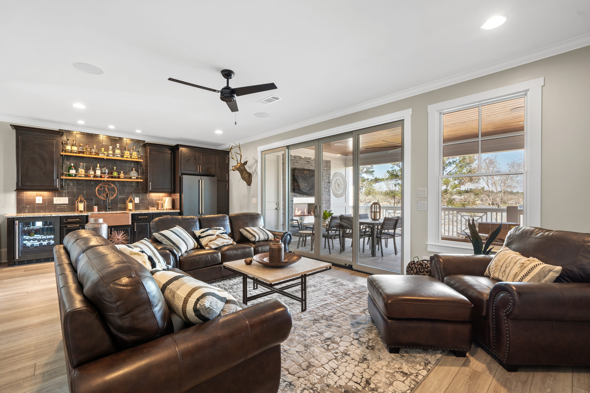 Full View of Living Room with Back Bar with Dark Wood and Tile Features |PAXISgroup