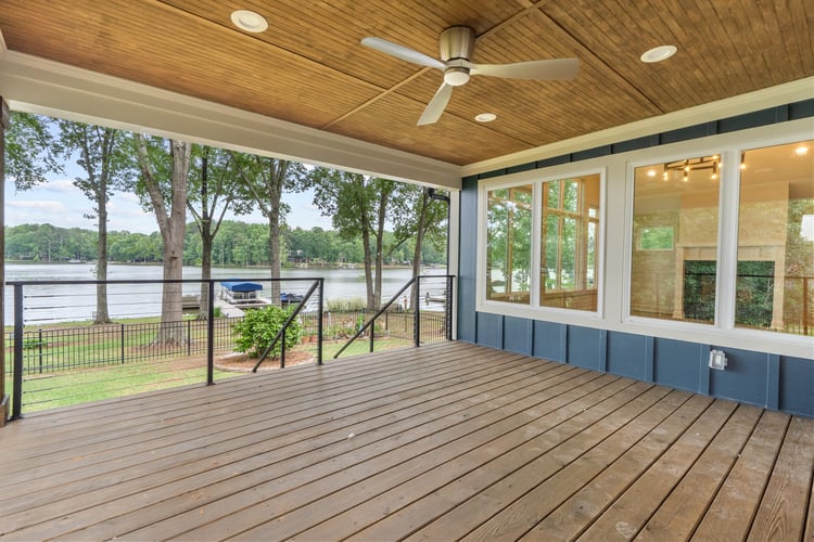 Outdoor deck with lake views in custom home remodel by Paxis Goup