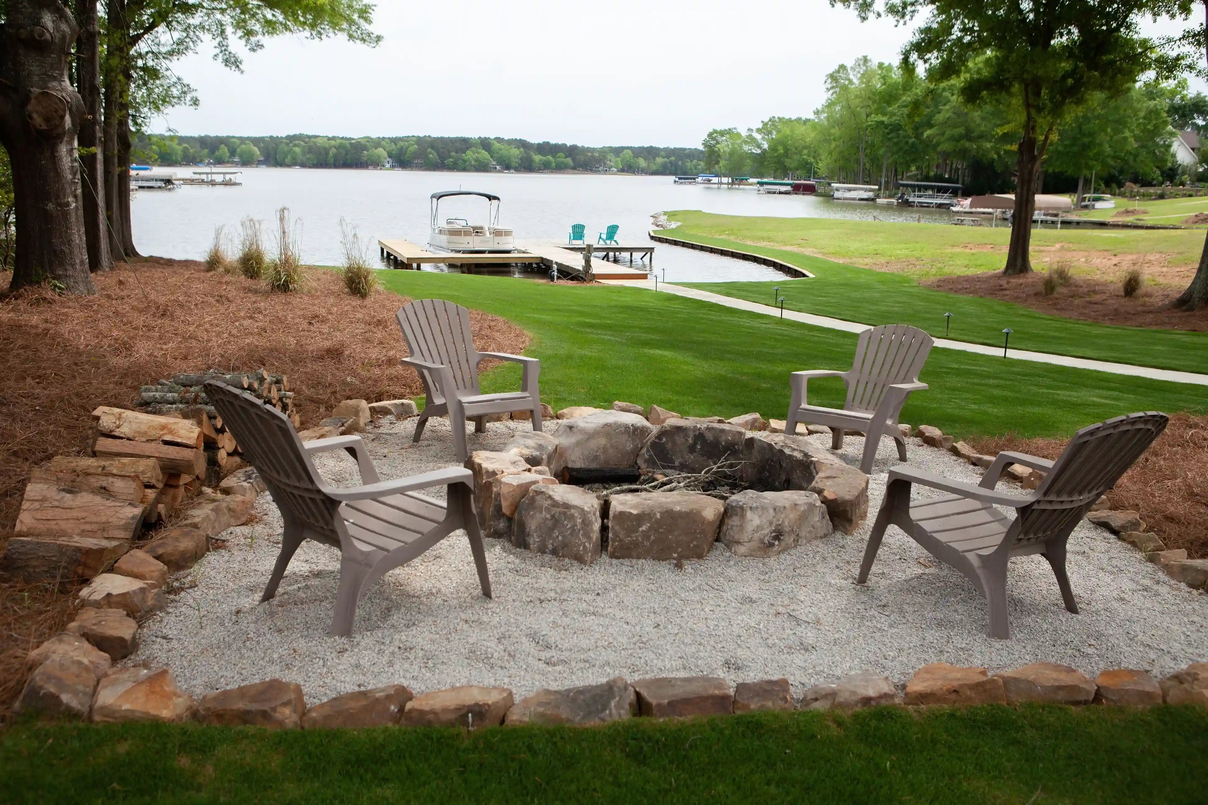 Fire Pit with Adirondack Chair Seating Overlooking Lakefront Property _ PAXISgroup Custom Home Builders in GA_11zon
