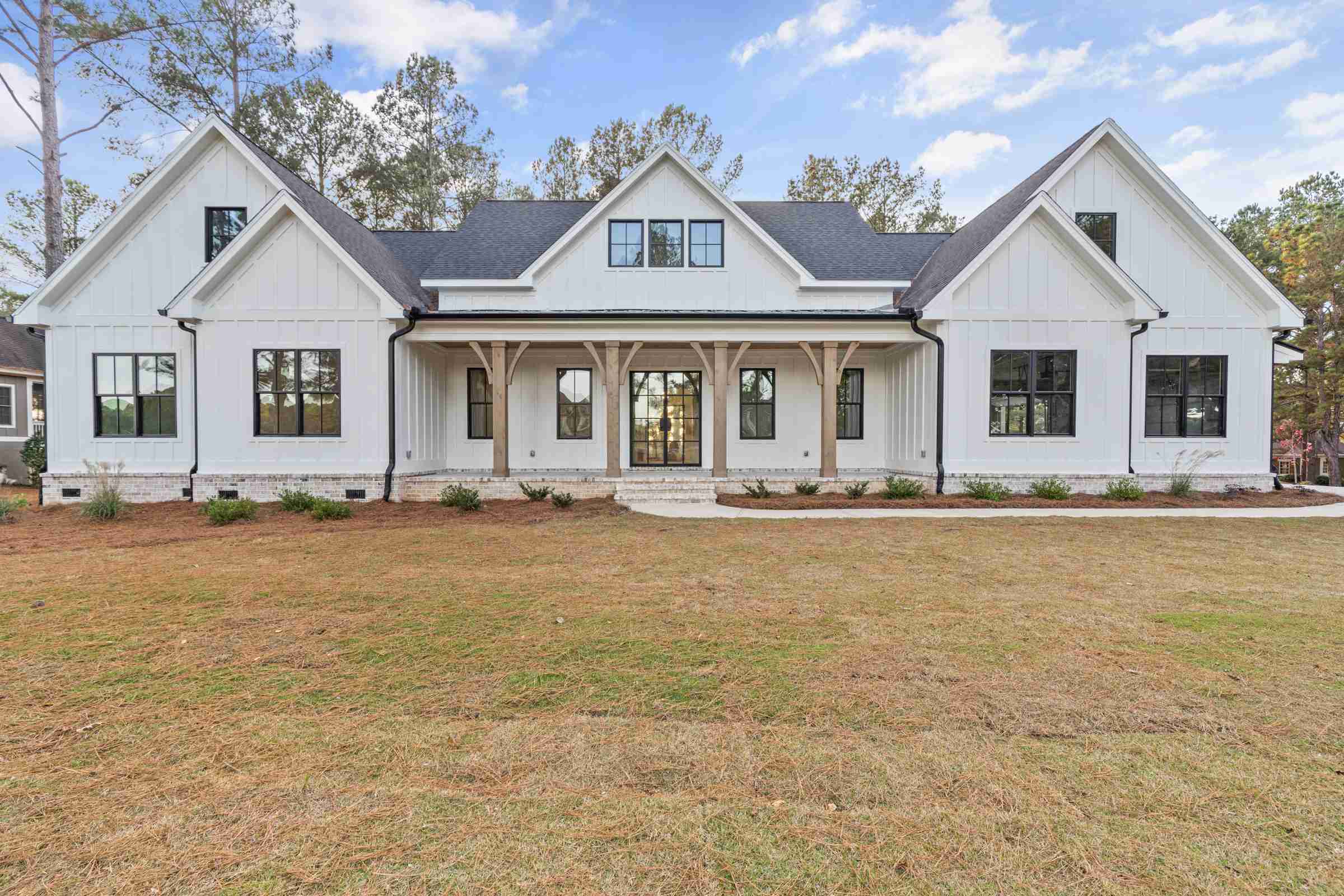 1 Paxis Indian Trail Front of custom home, front porch, white siding | Paxisgroup