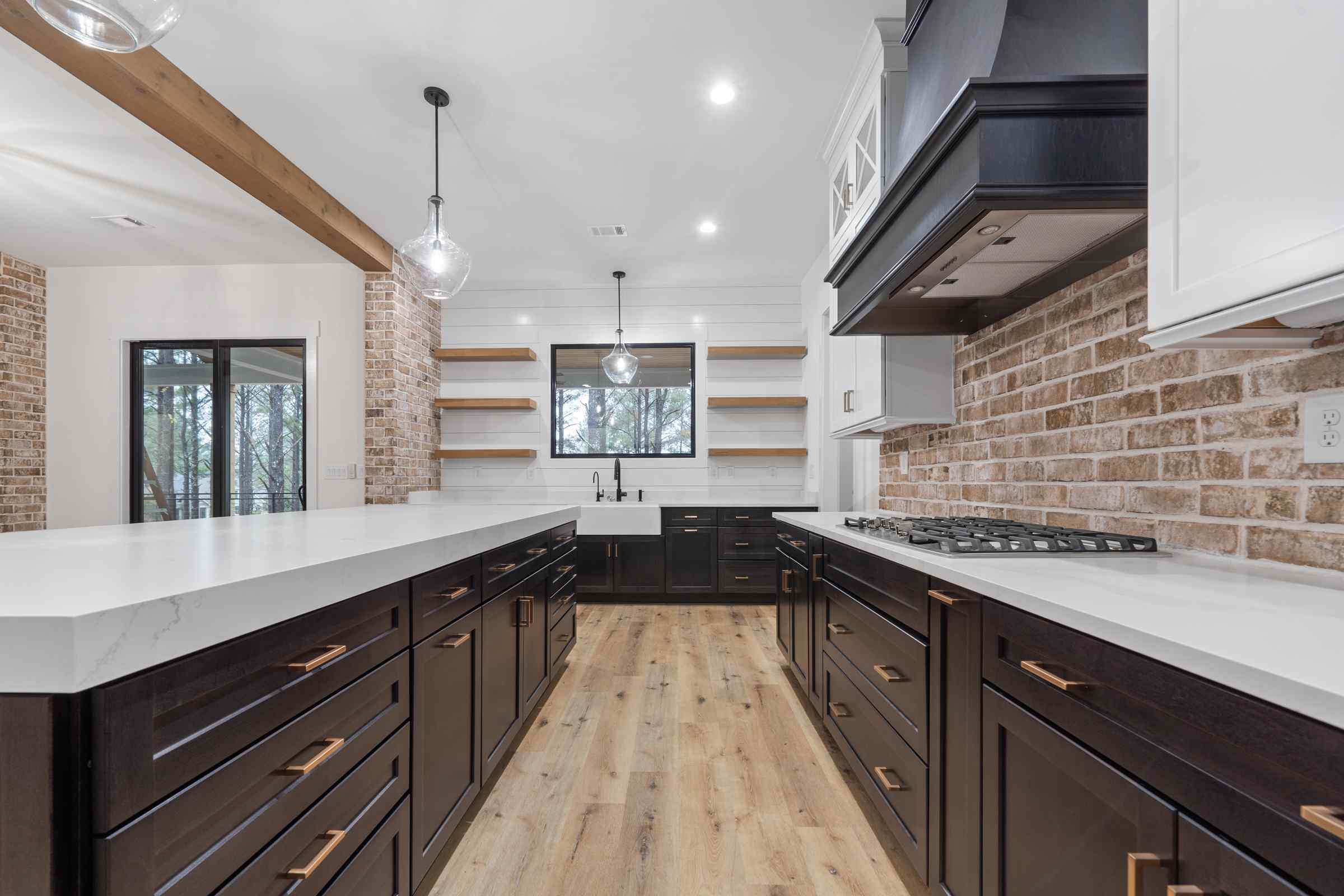 12 Paxis Indian Trail kitchen view exposed brick, blue cabinets, blue hood range, built in kitchen shelving | Paxisgroup