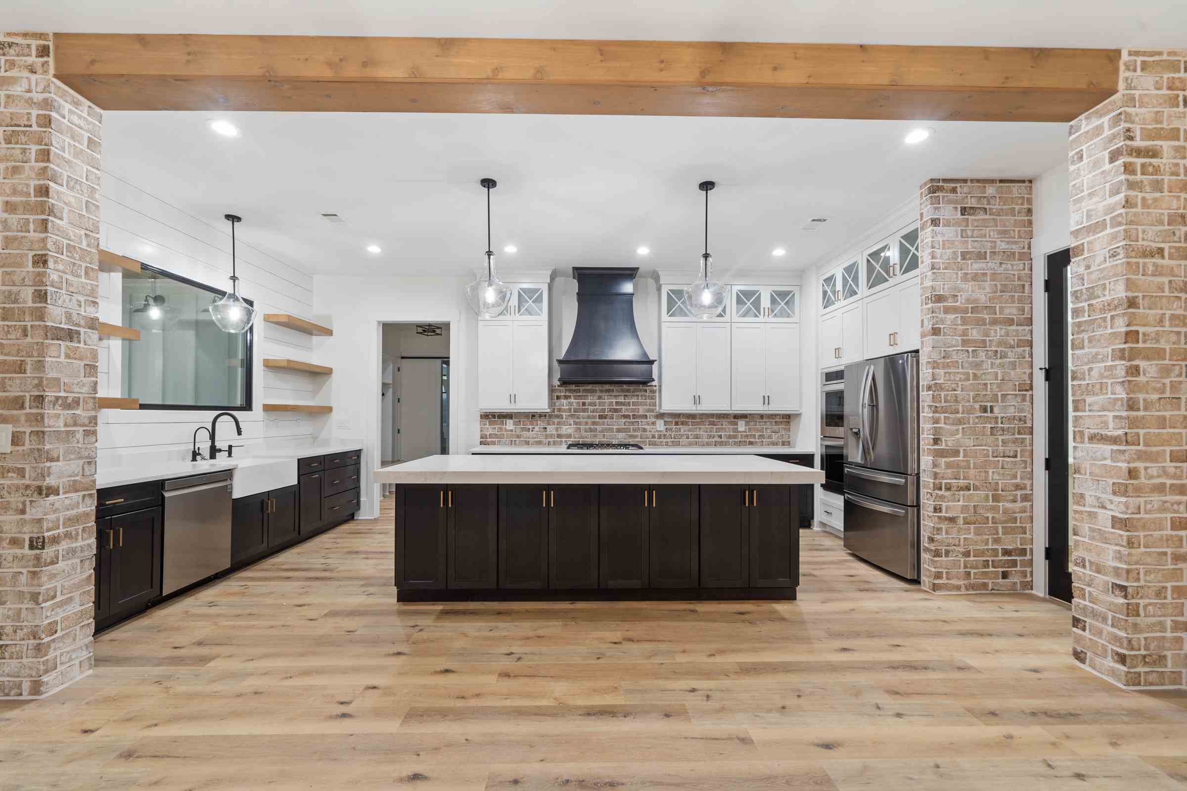 6 Paxis Indian Trail kitchen view from living area, large island, exposed brick, shiplap, farmhouse | Paxisgroup