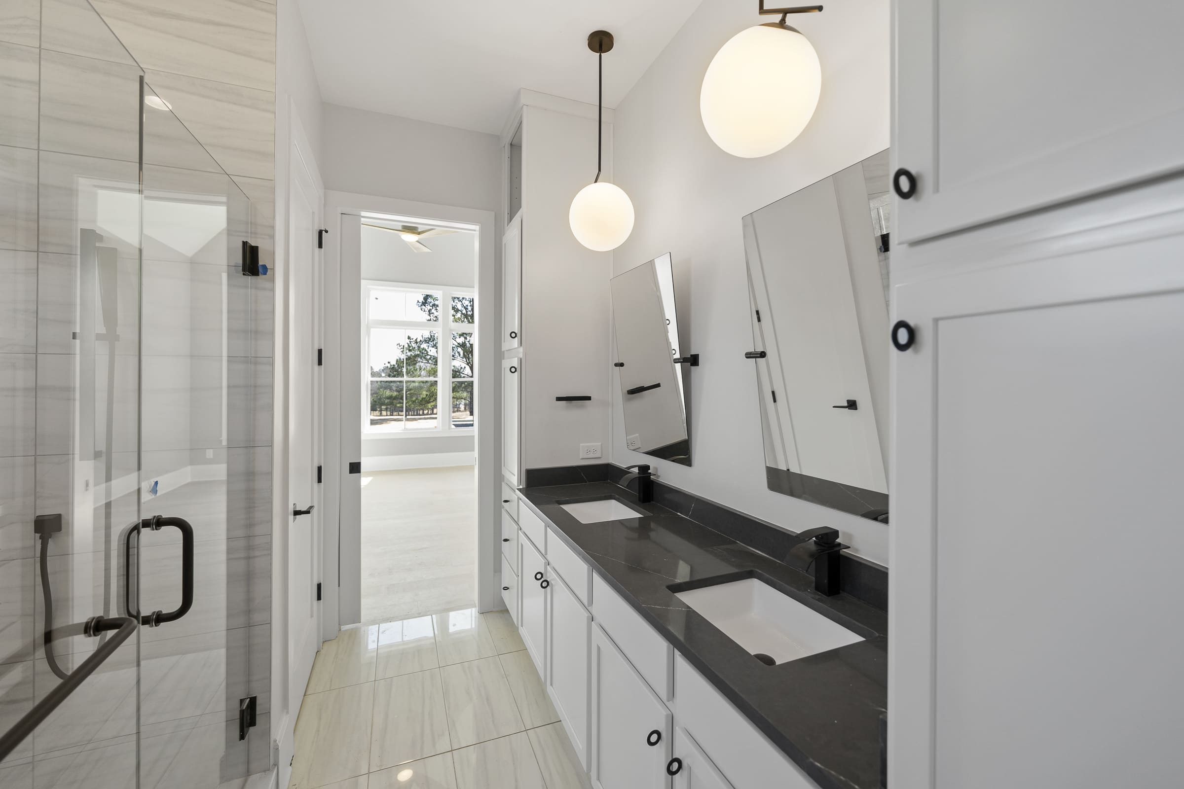 Dark Stone Double-Sink Vanity Counter Top with White Cabinetry | PAXISgroup