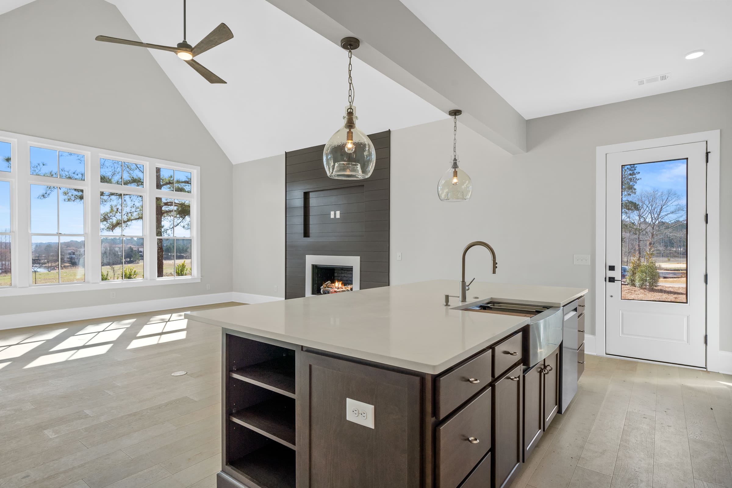 Side View of Living Space with Built-in Fire Place and View of Large Windows and View of the Golf Course |PAXISgroup