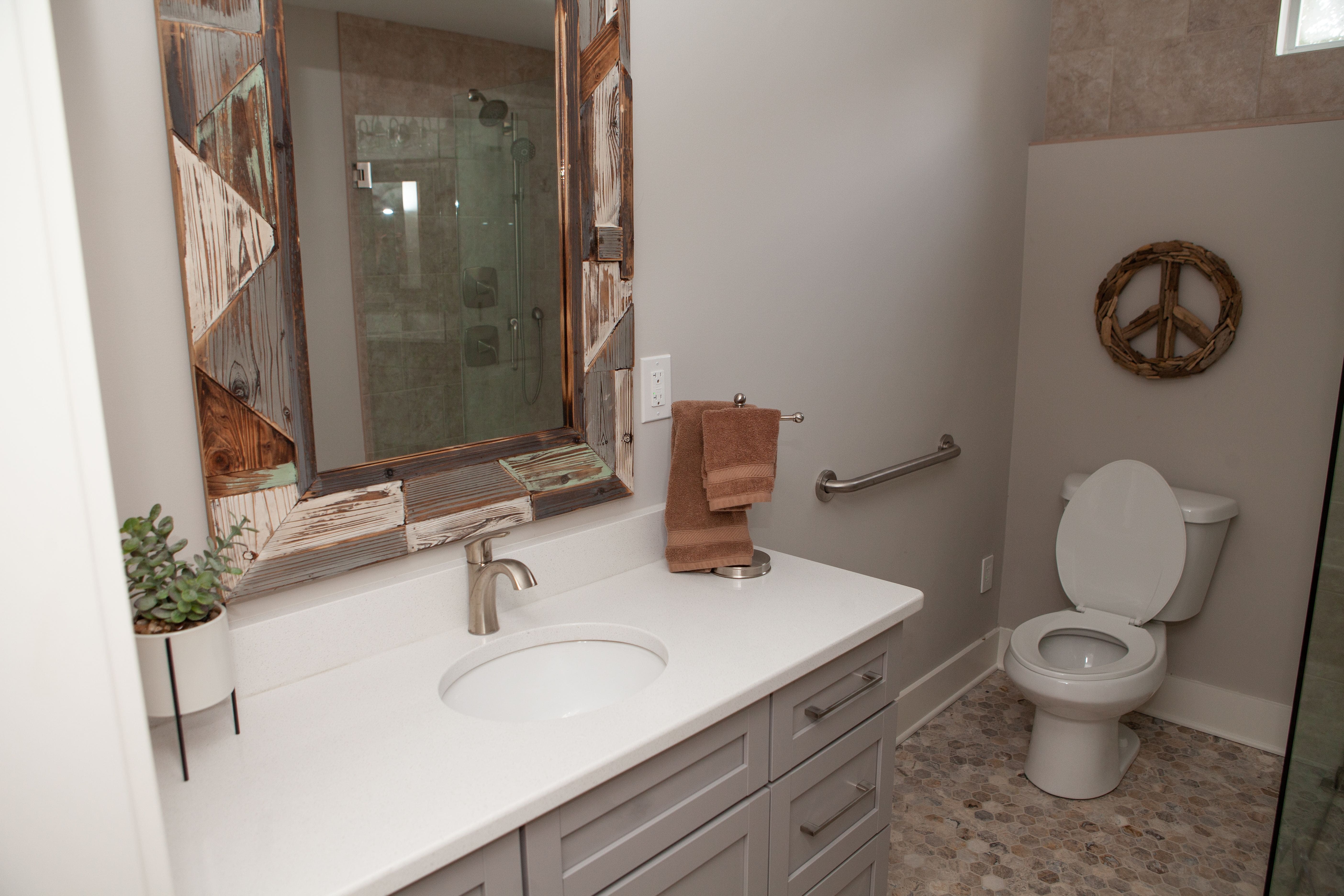 Boho Designed Bathroom with Geometric Flooring and Wood Accent Mirror | PAXISgroup Custom Home Builders in GA Boho Designed Bathroom with Geometric Flooring and Wood Accent Mirror | PAXISgroup Custom Home Builders in GA