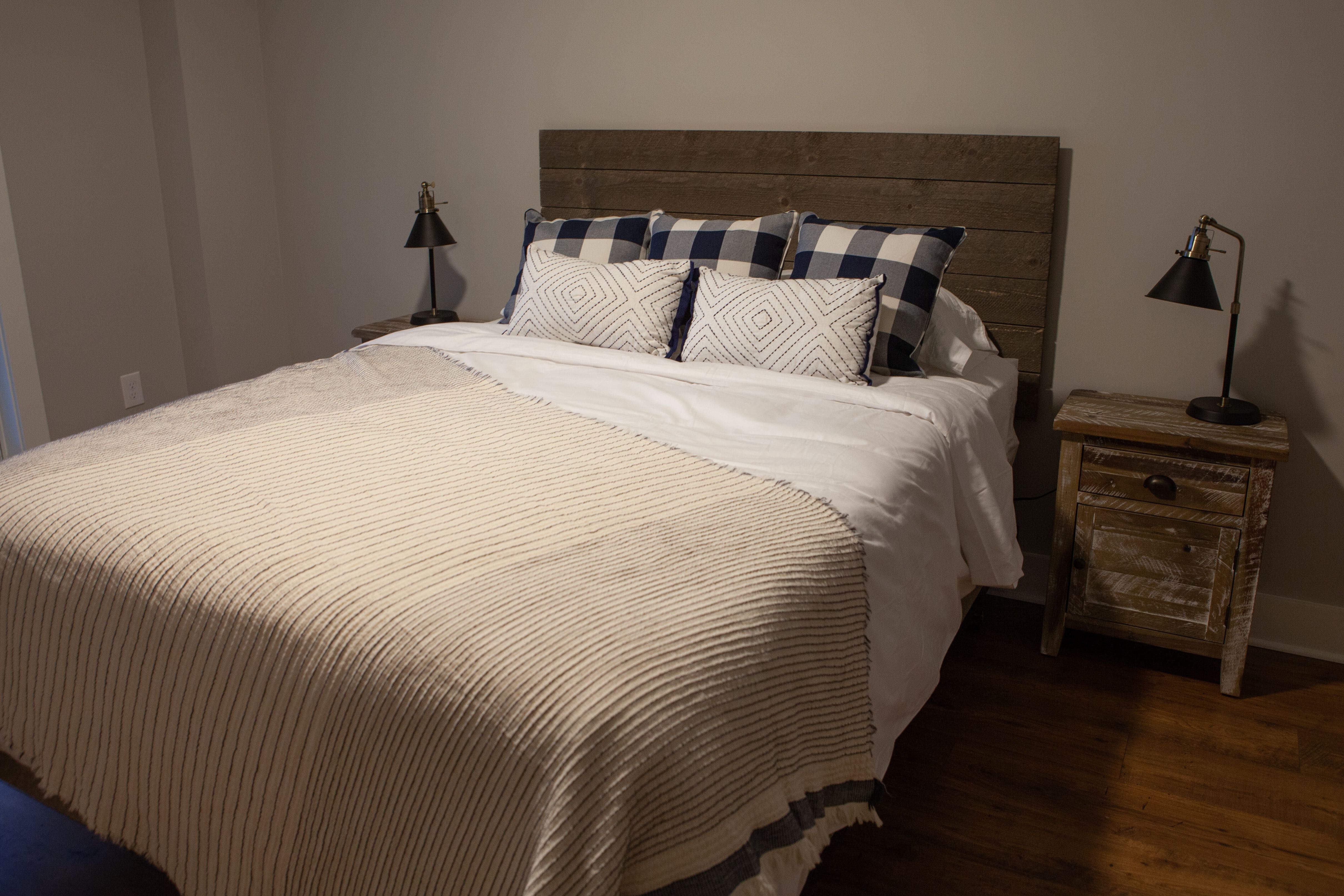Downstairs Guest Bedroom with Queen Bed and Wood Headboard | PAXISgroup Custom Home Builders in GA Downstairs Guest Bedroom with Queen Bed and Wood Headboard | PAXISgroup Custom Home Builders in GA