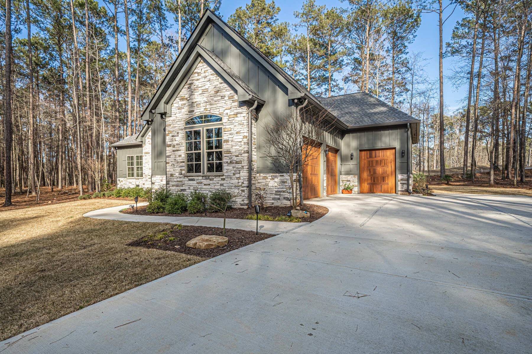 Freshly Paved Driveway and Wood Garage Doors |PAXISgroup