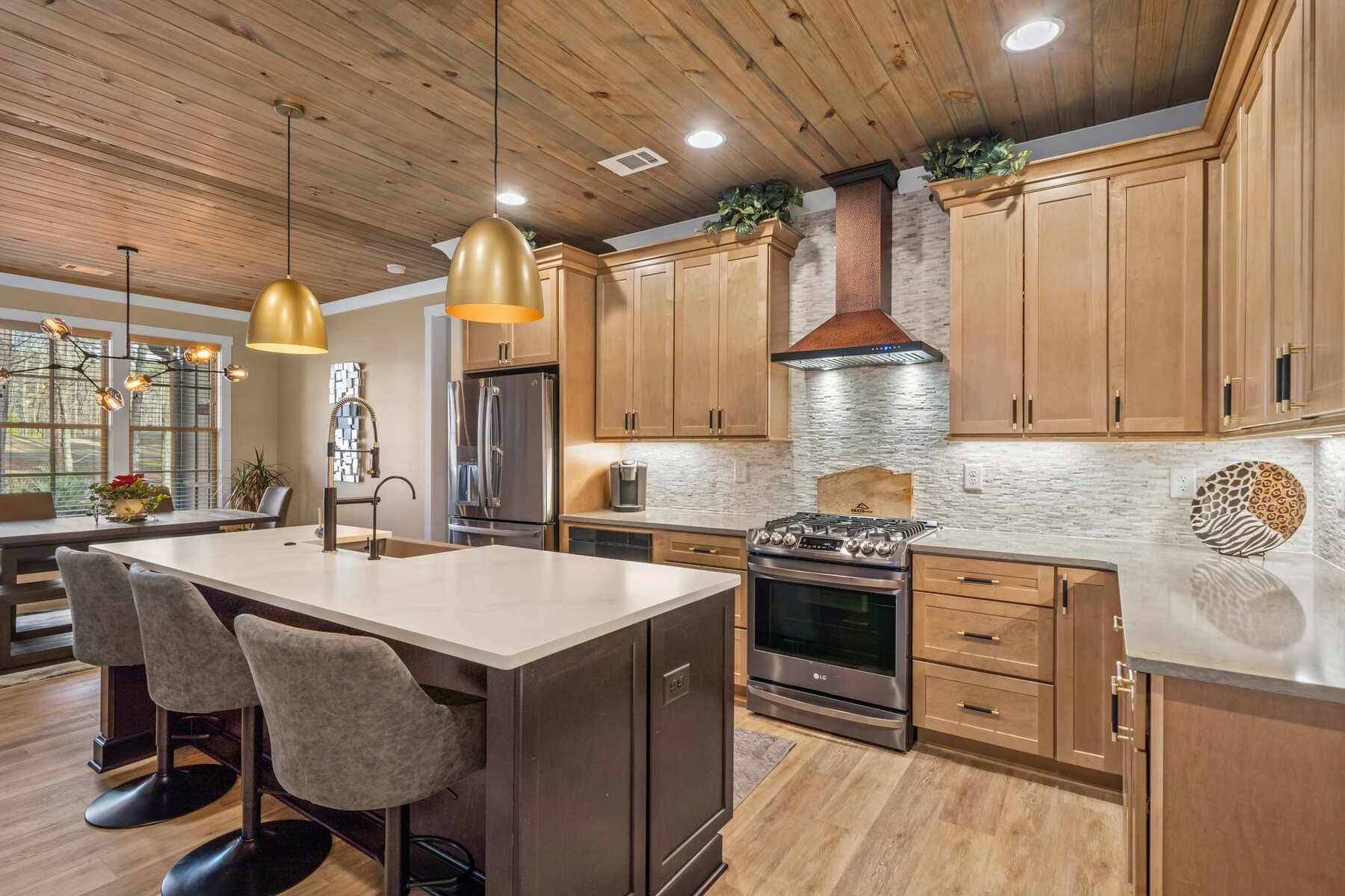 Kitchen Island with Light Grey Countertop and Light Grey Stone Backsplash |PAXISgroup