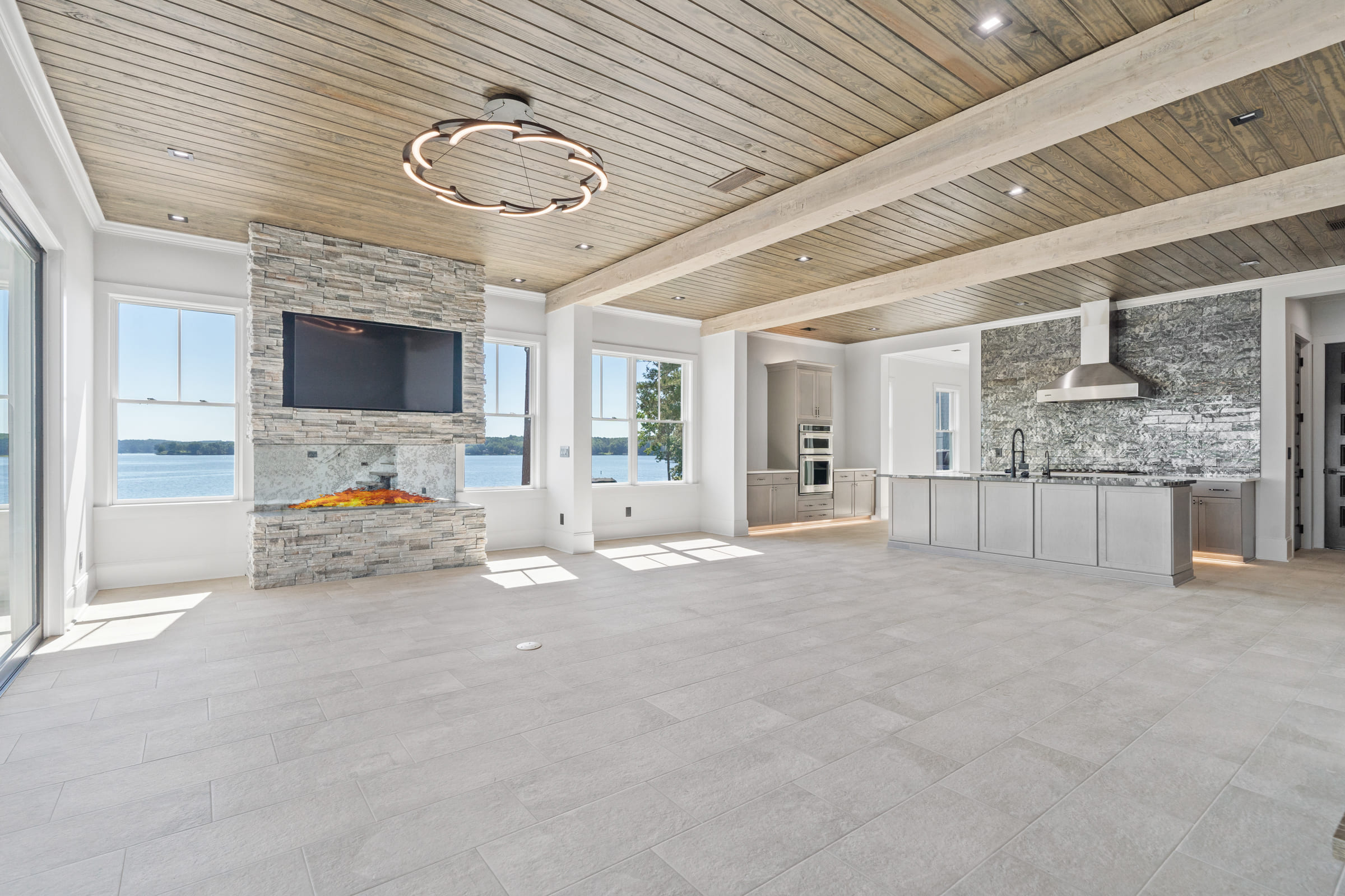 Beautiful Stone Fireplace and Kitchen View |PAXISgroup