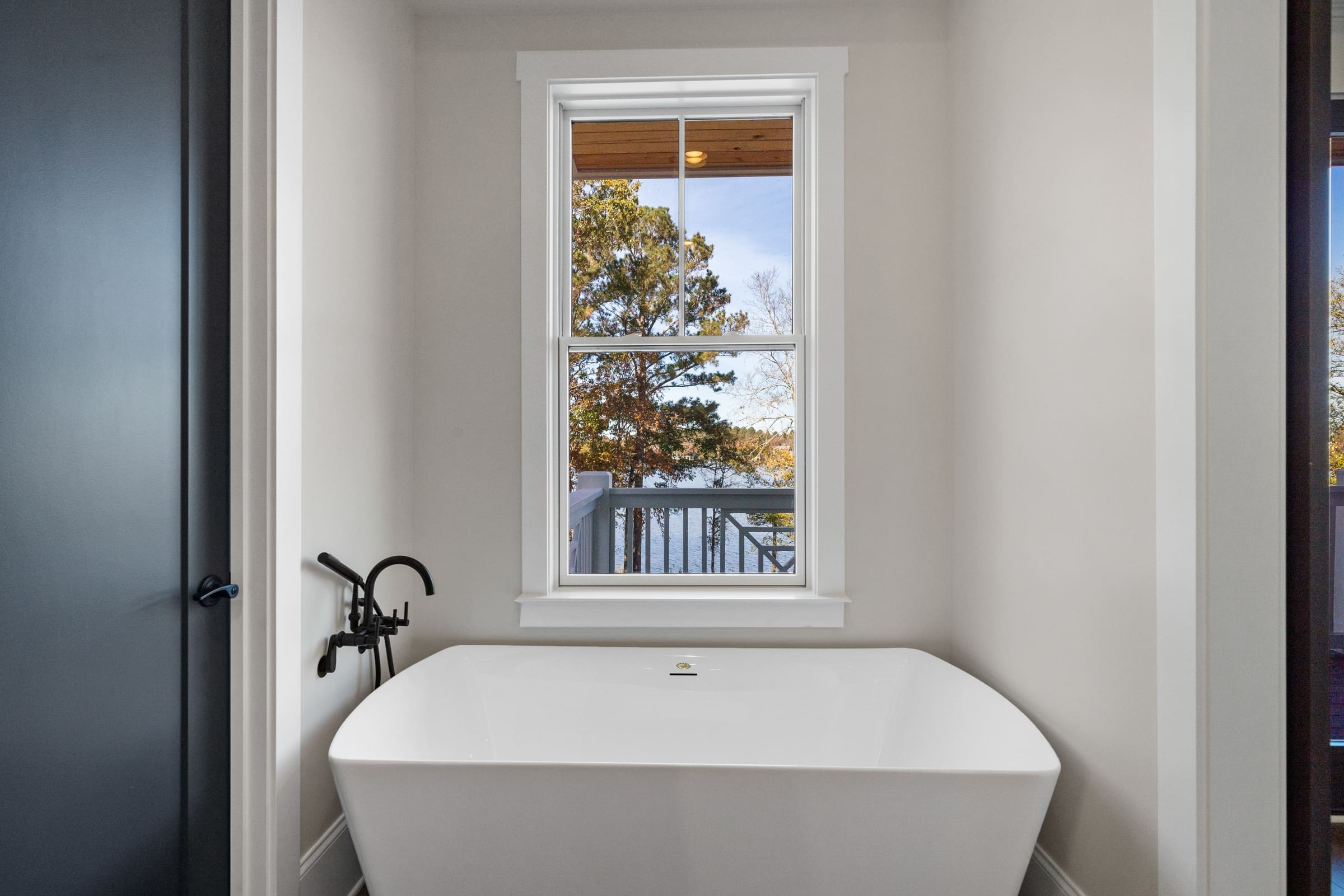 Master Bedroom Stand Alone Bath Tub with Single Window Above 