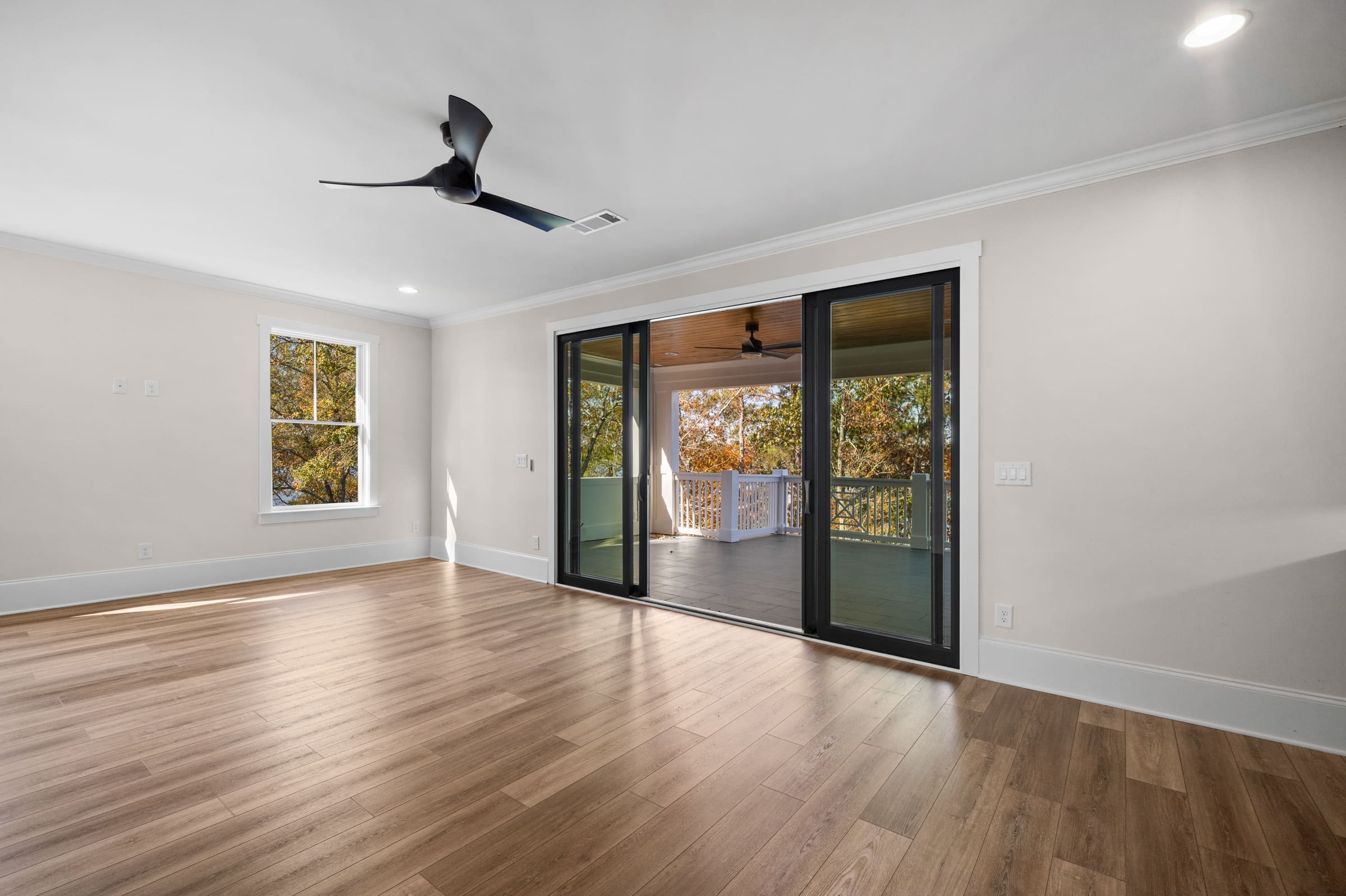 Full Glass Backdoor Patio and Dark Wood Ceiling Fan 