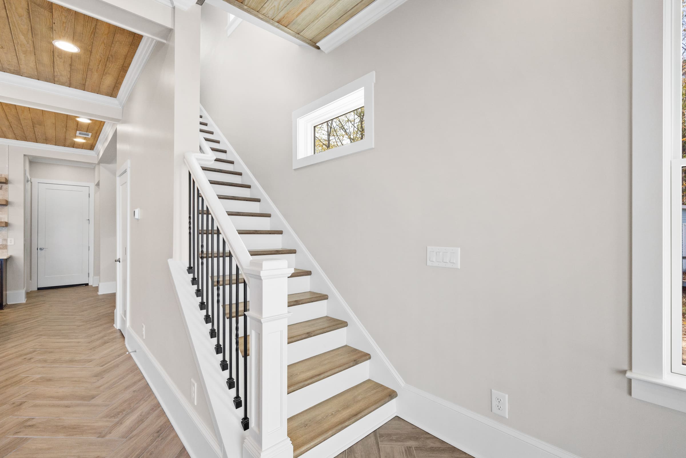White Staircase with Light Wooded Stairs and Small Rectangle Window 
