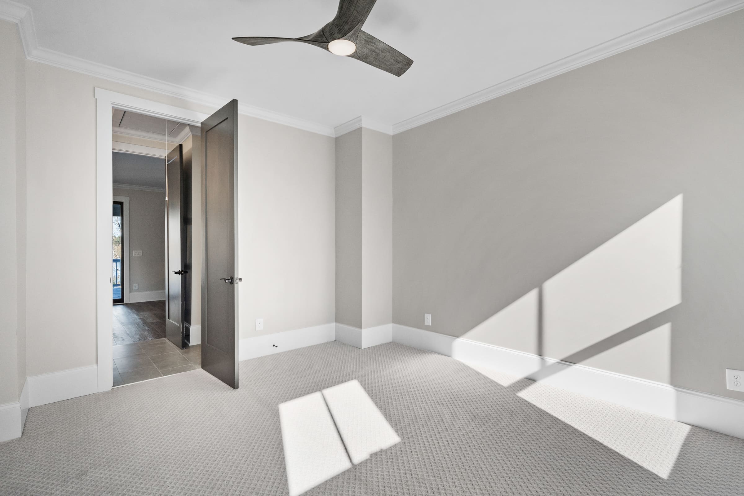 Carpeted Bedroom or Office with Dark Wood Ceiling Fan