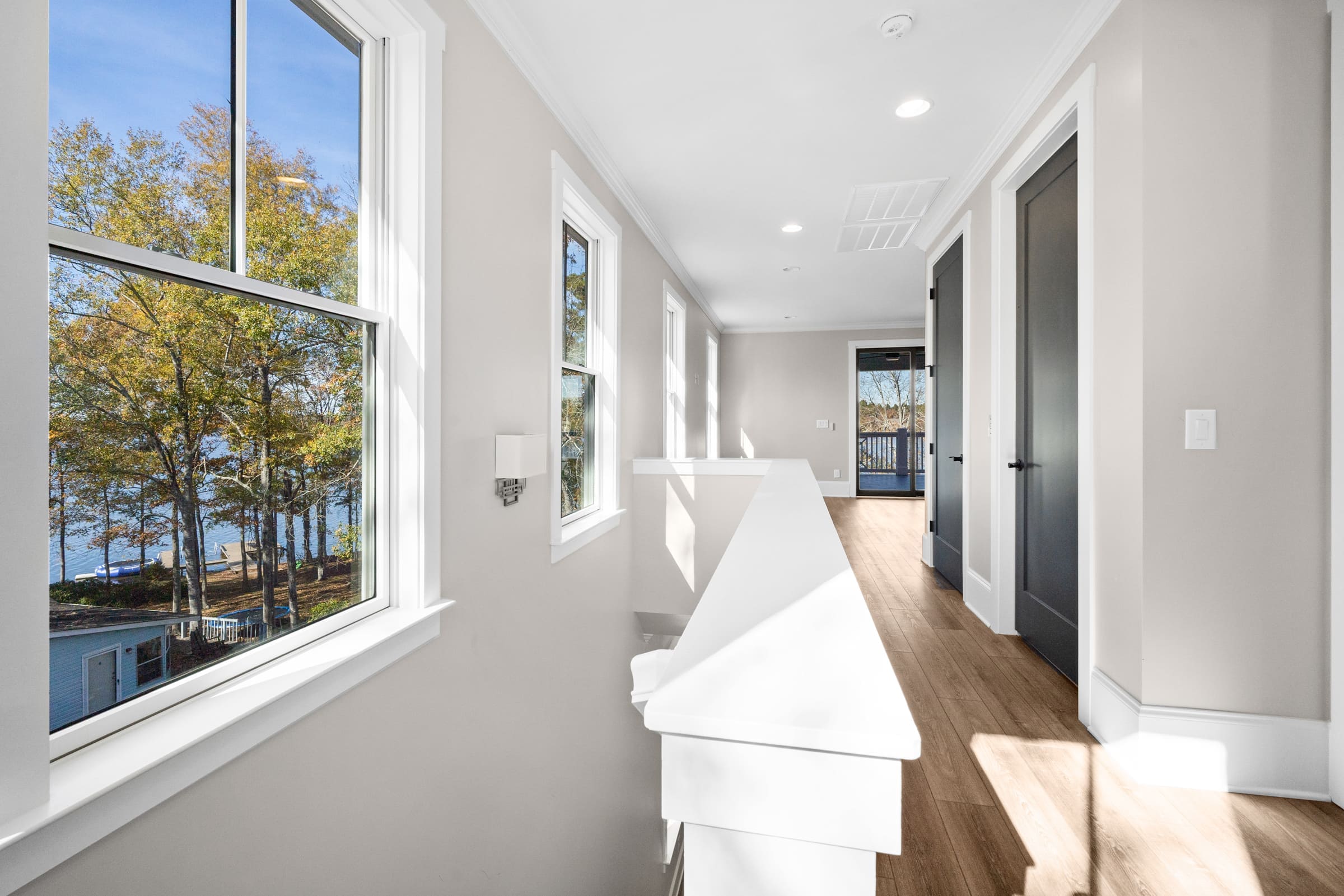 Upstairs Hallway Lined with Gorgeous White Framed Windows 