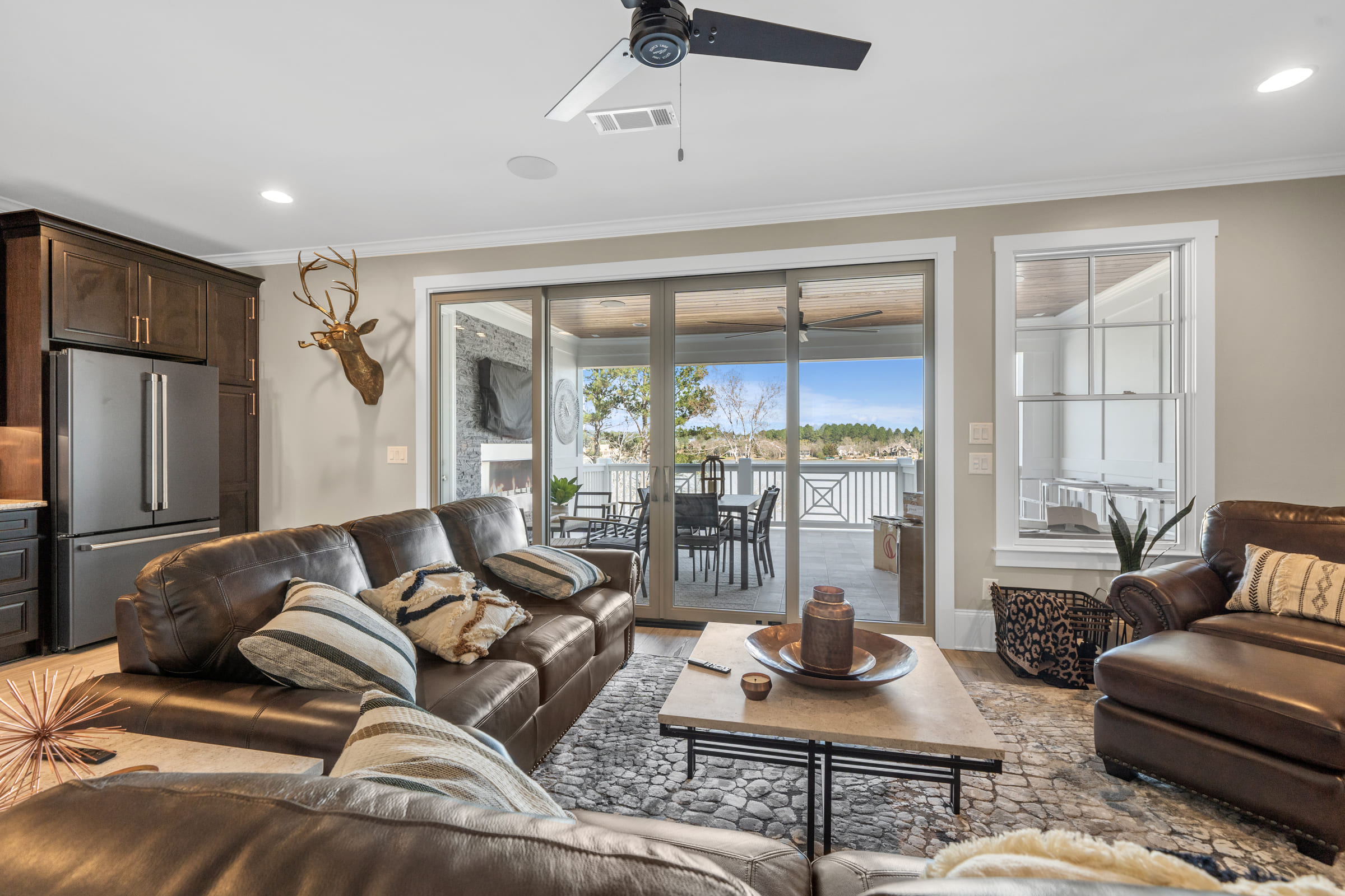 Beautiful Open Living room with Dark Wood Features and Sliding Deck Doors |PAXISgroup