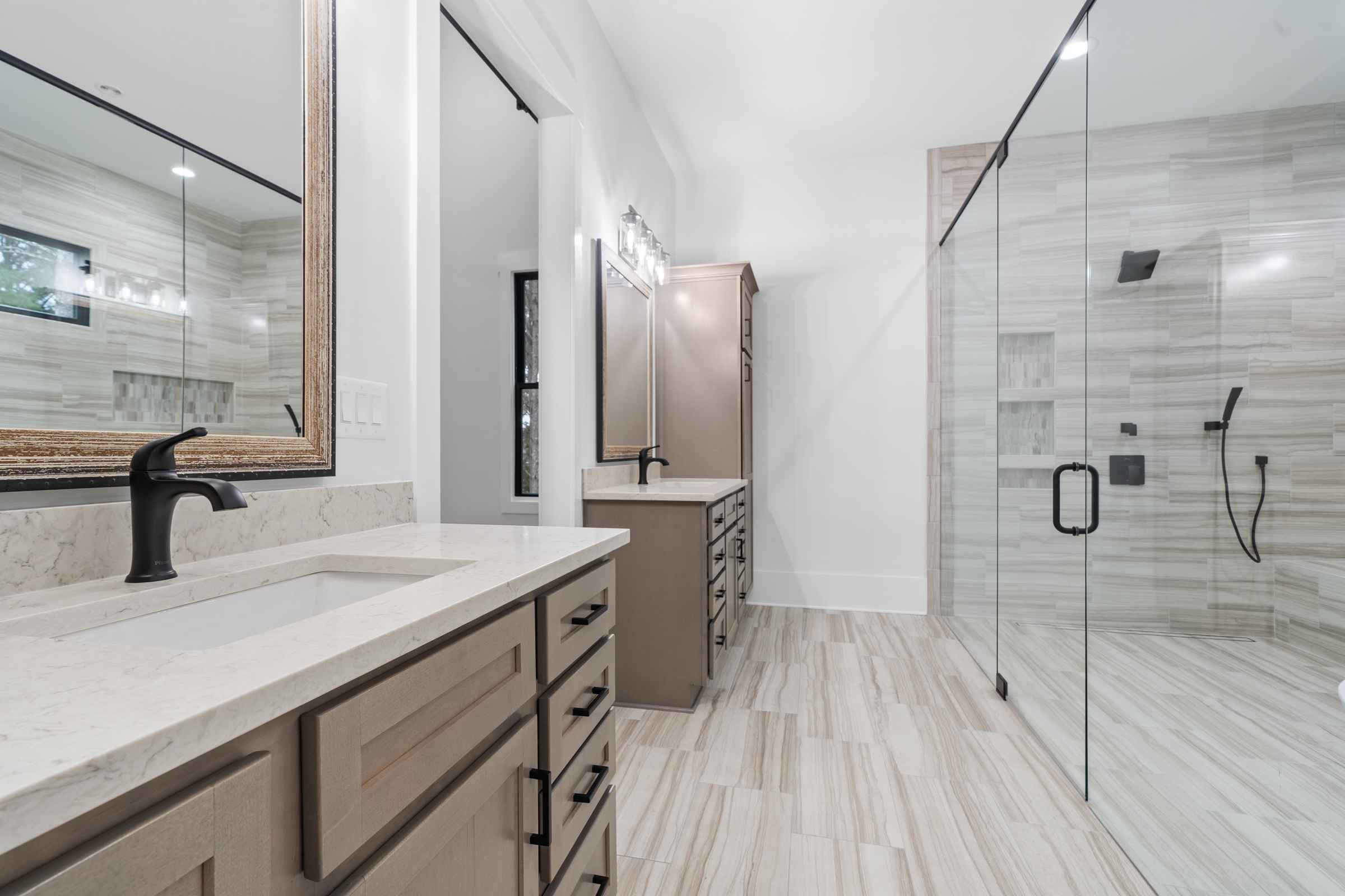 Paxis Indian Trail Bathroom with glass shower doors, walk-in shower, two vanities with sinks | Paxisgroup